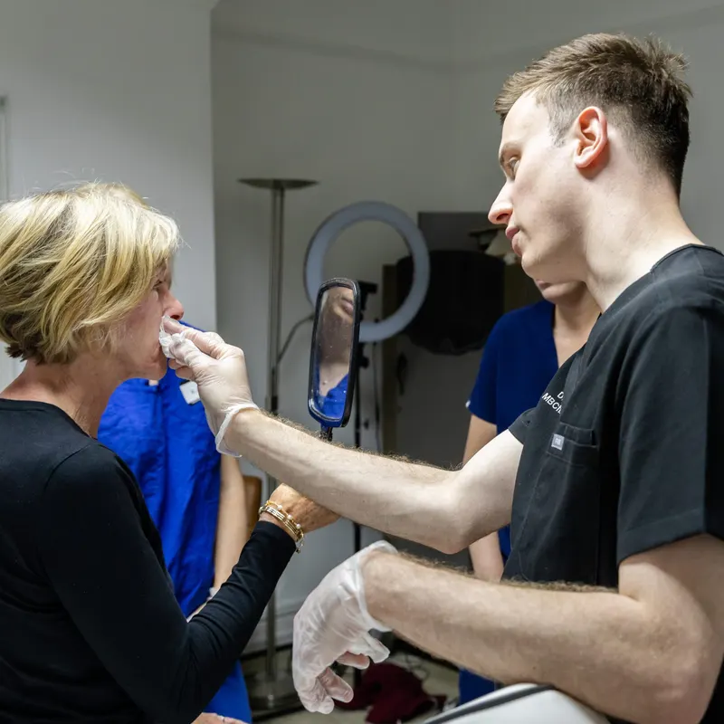 Dr Harry James performing a facial aesthetic treatment