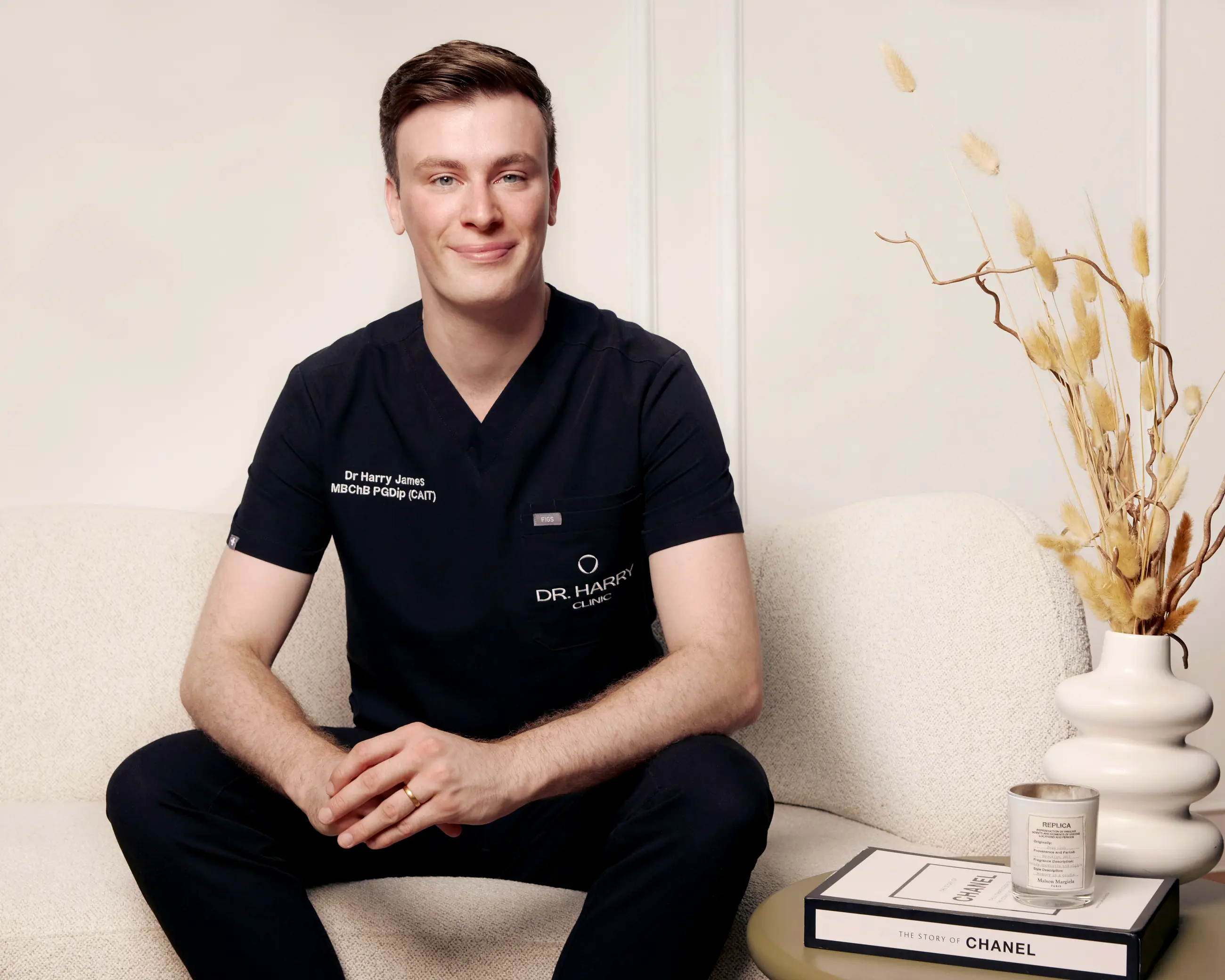 Dr Harry James seated on the clinic sofa, smiling